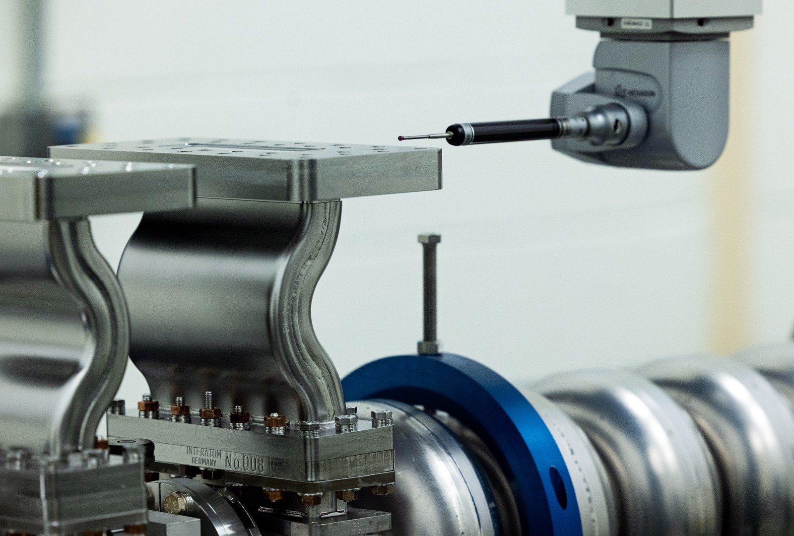 Coordinate measuring machine inspecting a precision metal component