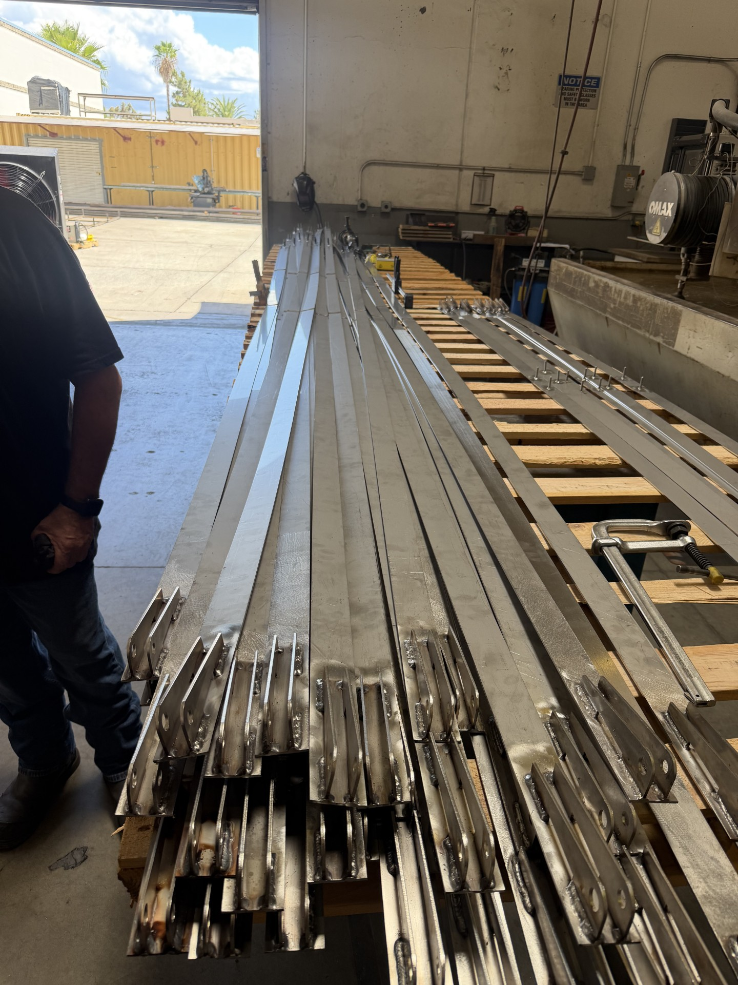 Welded fabricated assemblies staged on pallets in the shop